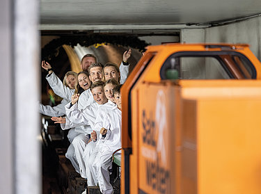Salzwelten Salzburg - Mine railway Salzwelten Salzburg - visitors on the mine train ride deep into the mountain