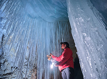 Eisriesenwelt Werfen Giant Ice Caves - Ice formations in the cave Eisriesenwelt Werfen Giant Ice Caves - A man with lantern on the ice in the cave